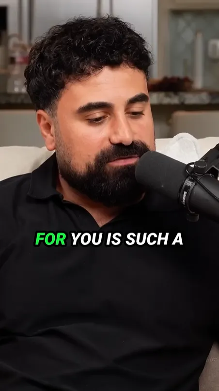 Vertical short of a bearded man in a black shirt speaking into a microphone, captioned 'FOR YOU IS SUCH A'.